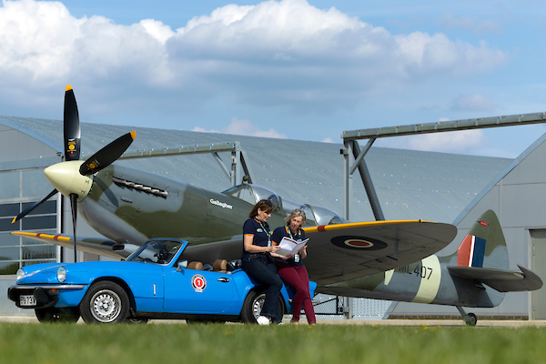 03/05/22

A brace of Spitfires. Parked next to the 1944 ‘Grace’ Spitfire, Claire Cochran and navigator Kay Pickering check the day’s road book leaning on the rear wing of Claire’s 1979 Triumph Spitfire ahead of the pair’s first ever rally.  

Competitors take part in the Spitfire Scramble. The two-day classic car rally starts and finishes at Sywell aerodrome in Northamptonshire. A series of off-road timed gravel and tarmac tests around hangars on the former WW2 airfield are followed on-road navigation and average speed challenges. The winning driver on the the Bespoke Rallies’ event will win a flight in a Spitfire.

All Rights Reserved: F Stop Press Ltd.  
+44 (0)7765 242650 www.fstoppress.com www.rkpphotography.co.uk